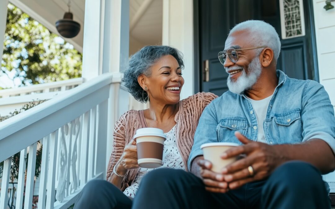 Senior couple sharing coffee and conversation on their front porch